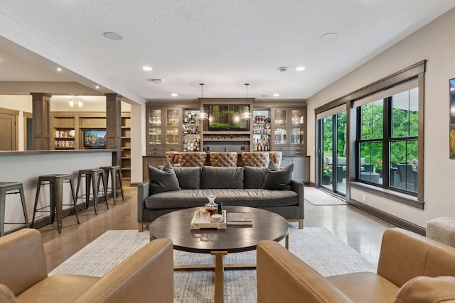 1432 25th St, Saint Joseph Twp, WI 54082 - living area featuring ornate columns, recessed lighting, and a textured ceiling