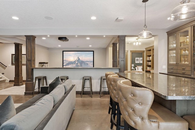 1432 25th St, Saint Joseph Twp, WI 54082 - bar featuring ornate columns, baseboards, recessed lighting, stairs, and pendant lighting