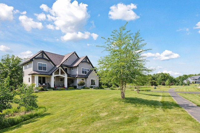 1432 25th St, Saint Joseph Twp, WI 54082 - craftsman-style house with a front yard, covered porch, stone siding, and board and batten siding