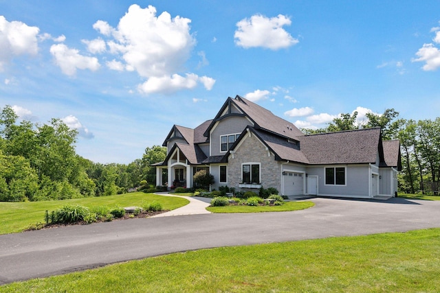 1432 25th St, Saint Joseph Twp, WI 54082 - craftsman-style home featuring a front yard, driveway, a garage, stone siding, and roof with shingles