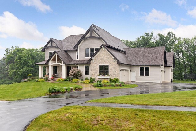 1432 25th St, Saint Joseph Twp, WI 54082 - craftsman inspired home featuring stone siding, asphalt driveway, a garage, a front lawn, and a shingled roof