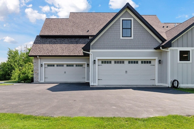 1432 25th St, Saint Joseph Twp, WI 54082 - view of front of house with a shingled roof, board and batten siding, and asphalt driveway
