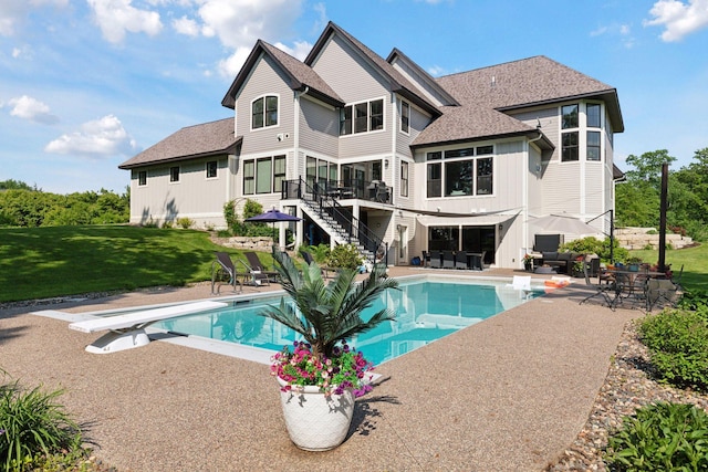 1432 25th St, Saint Joseph Twp, WI 54082 - swimming pool featuring a diving board, a yard, a patio, stairway, and a wooden deck