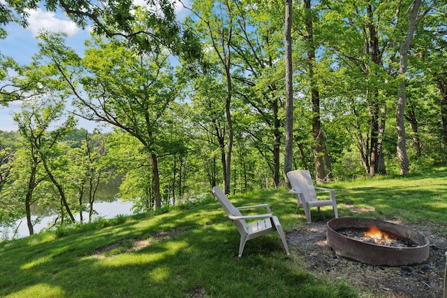 1432 25th St, Saint Joseph Twp, WI 54082 - view of green lawn featuring an outdoor fire pit, a water view, and a wooded view