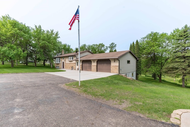 23725 240th Ave, Aurdal Twp, MN 56537 - view of front of property featuring brick siding, driveway, a front lawn, a chimney, and an attached garage