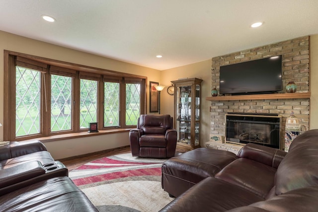 23725 240th Ave, Aurdal Twp, MN 56537 - living room featuring baseboards, wood finished floors, a brick fireplace, and recessed lighting