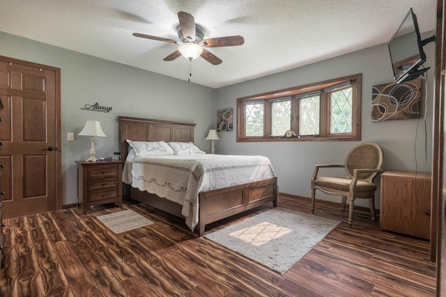 23725 240th Ave, Aurdal Twp, MN 56537 - bedroom featuring dark wood finished floors, a textured ceiling, a ceiling fan, and baseboards