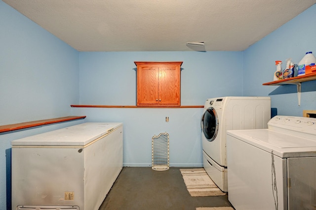 106 4th Ave NW, Rice, MN 56367 - laundry room featuring separate washer and dryer, cabinet space, baseboards, and a textured ceiling