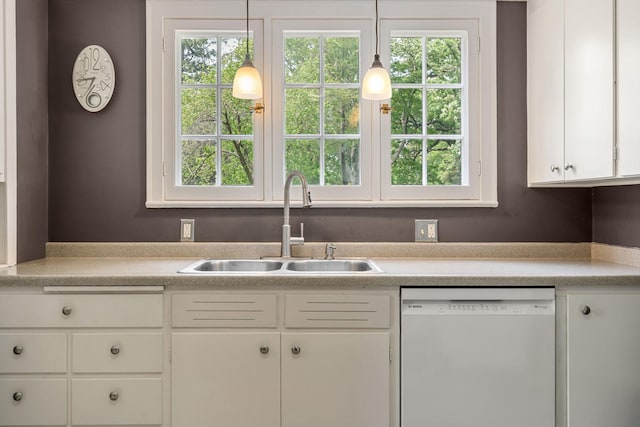 808 4th St SW, Austin, MN 55912 - kitchen featuring white dishwasher, a sink, light countertops, and white cabinetry