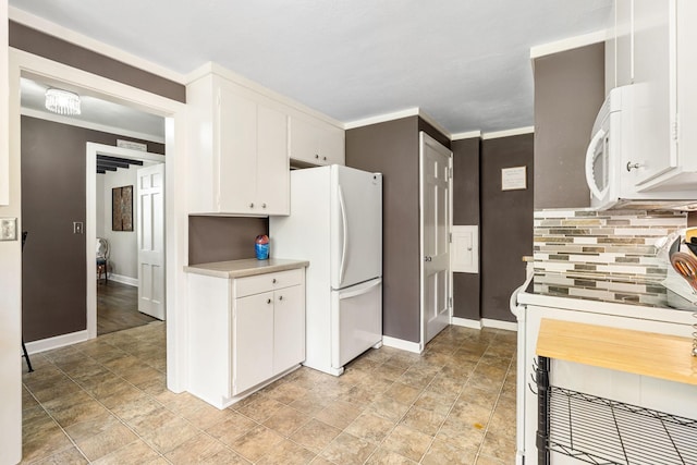 808 4th St SW, Austin, MN 55912 - kitchen with white appliances, baseboards, light countertops, and stone finish floors
