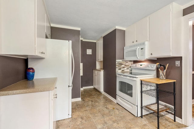 808 4th St SW, Austin, MN 55912 - kitchen with white appliances, baseboards, light countertops, white cabinetry, and tasteful backsplash