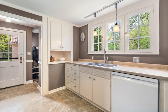 808 4th St SW, Austin, MN 55912 - kitchen featuring dishwasher, a sink, light countertops, hanging light fixtures, and white cabinetry