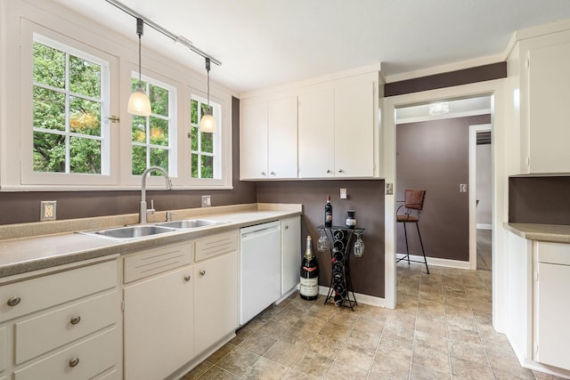 808 4th St SW, Austin, MN 55912 - kitchen with white dishwasher, a sink, white cabinets, and light countertops