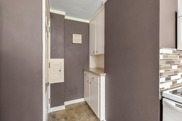 808 4th St SW, Austin, MN 55912 - hall with baseboards, dark stone finish flooring, and a textured ceiling