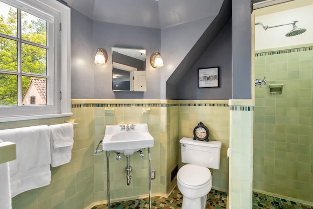 808 4th St SW, Austin, MN 55912 - full bathroom with a shower stall, tile walls, toilet, a sink, and a wainscoted wall