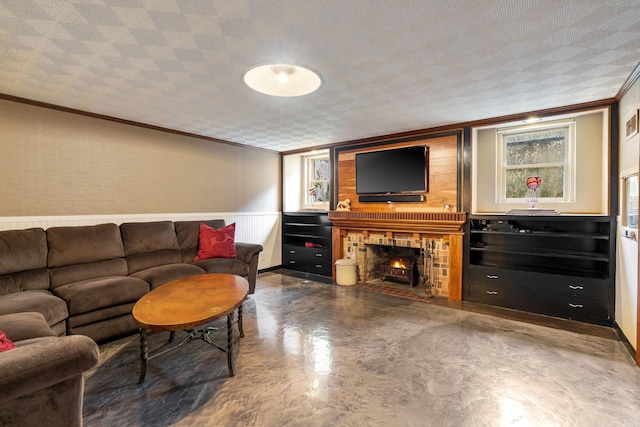 808 4th St SW, Austin, MN 55912 - living room featuring ornamental molding, concrete floors, a fireplace, and a wainscoted wall