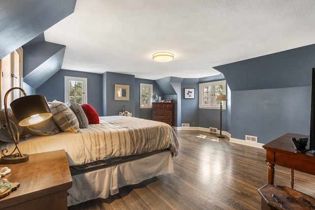 808 4th St SW, Austin, MN 55912 - bedroom with wood finished floors, baseboards, multiple windows, and a textured ceiling