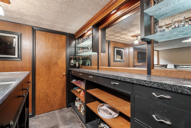 808 4th St SW, Austin, MN 55912 - kitchen with dark cabinets, open shelves, concrete floors, and dark countertops