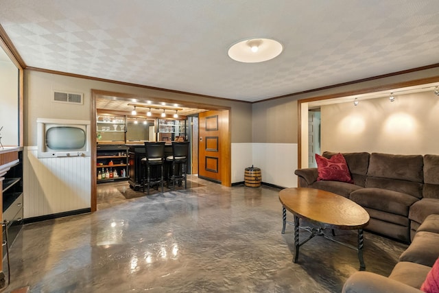 808 4th St SW, Austin, MN 55912 - living area with a bar, wainscoting, and crown molding