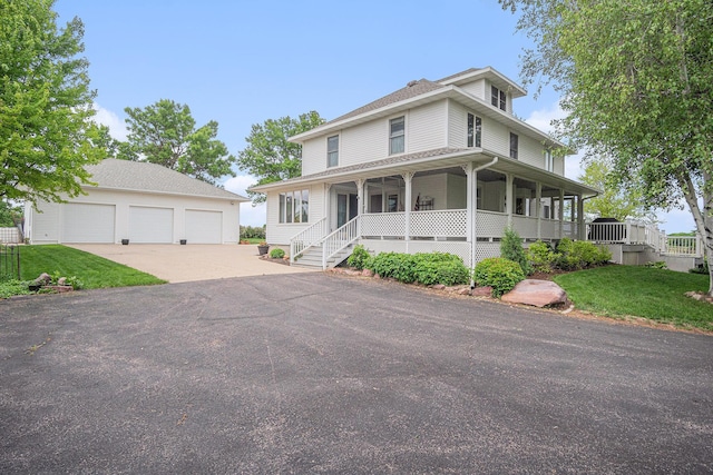 102 Walnut Ave, Luverne, MN 56156 - farmhouse-style home featuring an outdoor structure, a garage, a front lawn, and covered porch