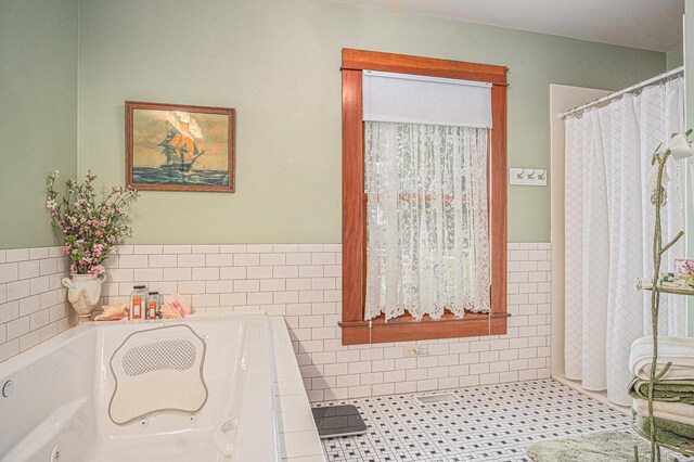 102 Walnut Ave, Luverne, MN 56156 - full bathroom with a garden tub, tile walls, wainscoting, and a shower with curtain