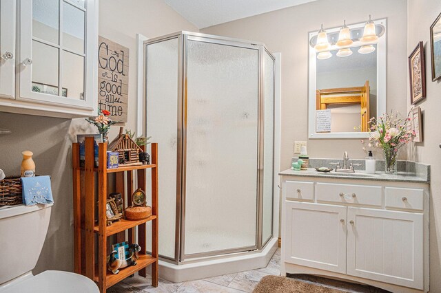 102 Walnut Ave, Luverne, MN 56156 - bathroom with a stall shower, vanity, toilet, and marble finish flooring