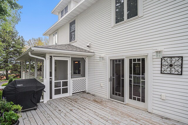 102 Walnut Ave, Luverne, MN 56156 - wooden terrace featuring area for grilling and a sunroom