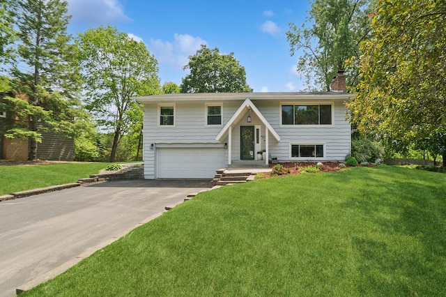 15613 Boulder Creek Dr, Minnetonka, MN 55345 - split foyer home featuring a chimney, driveway, a garage, and a front yard