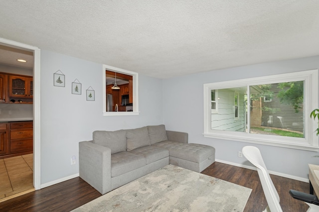 15613 Boulder Creek Dr, Minnetonka, MN 55345 - living area with dark wood finished floors, a textured ceiling, and baseboards