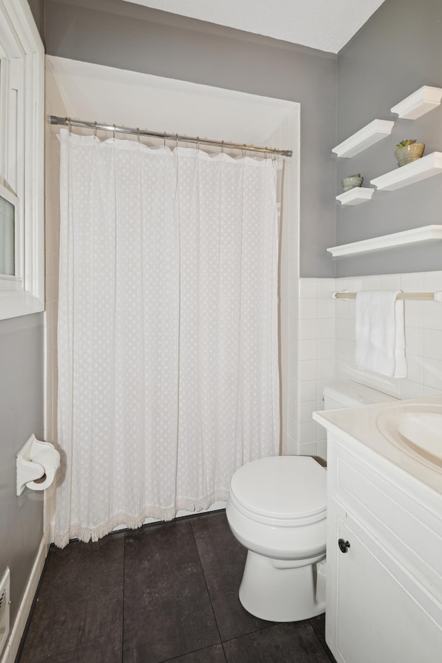 15613 Boulder Creek Dr, Minnetonka, MN 55345 - bathroom with toilet, vanity, tile patterned floors, and a shower with curtain