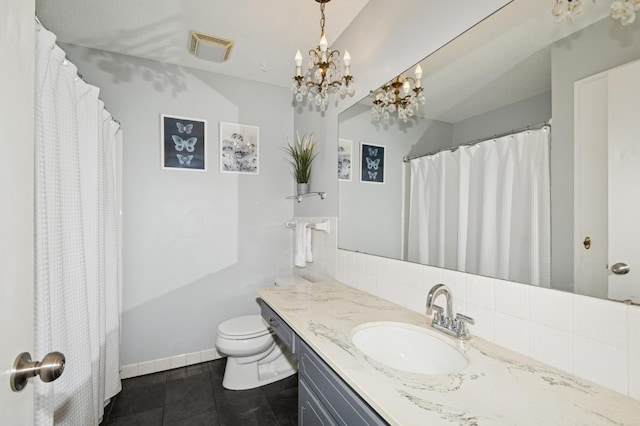 15613 Boulder Creek Dr, Minnetonka, MN 55345 - bathroom with tile patterned floors, vanity, toilet, a chandelier, and backsplash