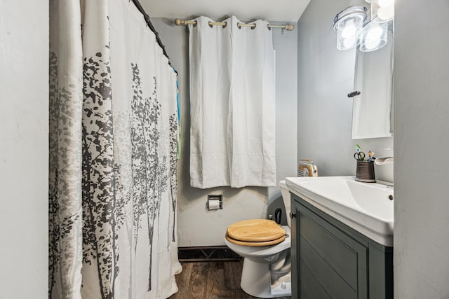 736 24th Ave N, Saint Cloud, MN 56303 - bathroom with vanity, toilet, wood finished floors, and curtained shower