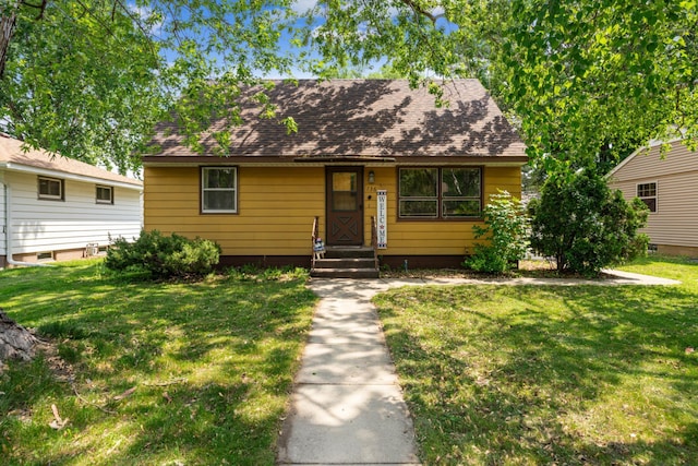 736 24th Ave N, Saint Cloud, MN 56303 - view of front of home with a front lawn and roof with shingles