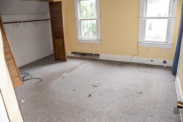 808 Franklin Ave, Wabasha, MN 55981 - unfurnished bedroom featuring multiple windows, a closet, and baseboards