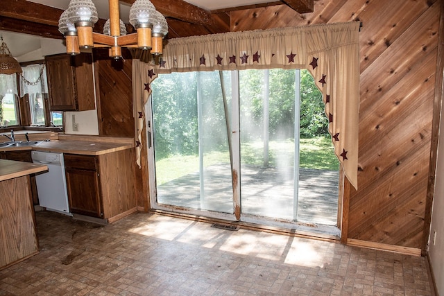 808 Franklin Ave, Wabasha, MN 55981 - kitchen featuring dishwasher, brick patterned floors, wood walls, a chandelier, and beam ceiling