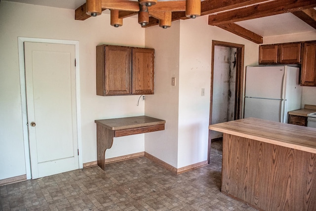 808 Franklin Ave, Wabasha, MN 55981 - kitchen with freestanding refrigerator, brown cabinets, beam ceiling, and butcher block countertops