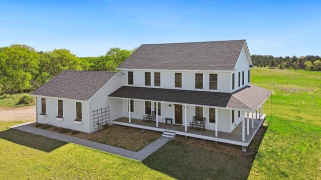 13985 120th St N, Stillwater, MN 55082 - farmhouse inspired home with a front lawn, a porch, and roof with shingles