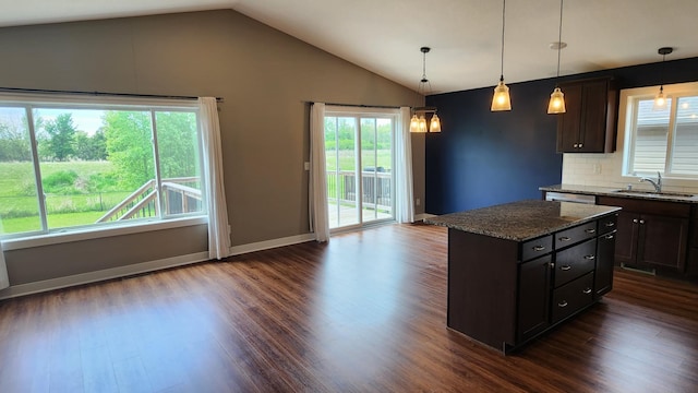 5687 Prosper Ave NW, Rochester, MN 55901 - kitchen with a sink, vaulted ceiling, dark wood-style floors, decorative backsplash, and stone countertops