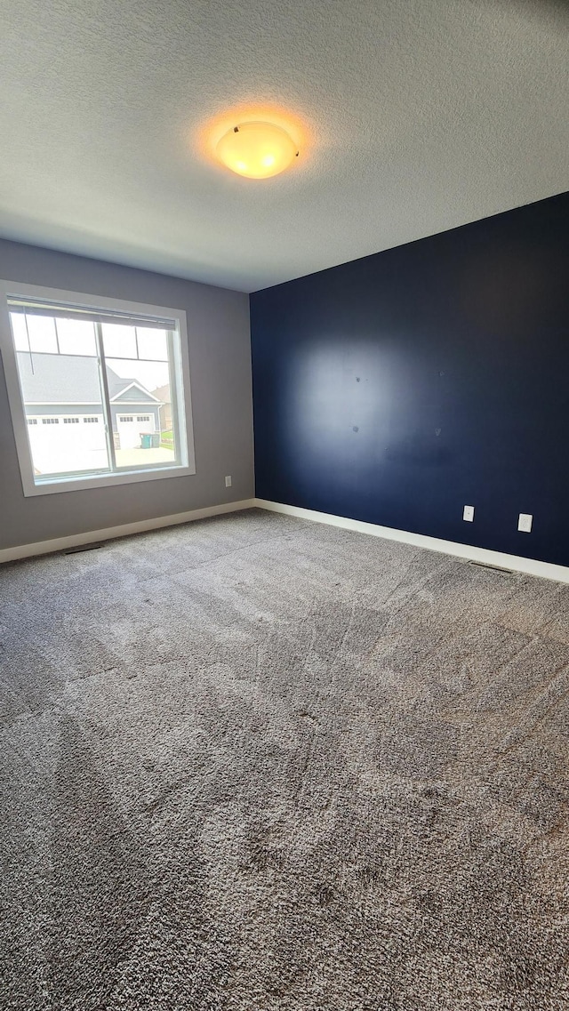 5687 Prosper Ave NW, Rochester, MN 55901 - carpeted empty room featuring baseboards and a textured ceiling