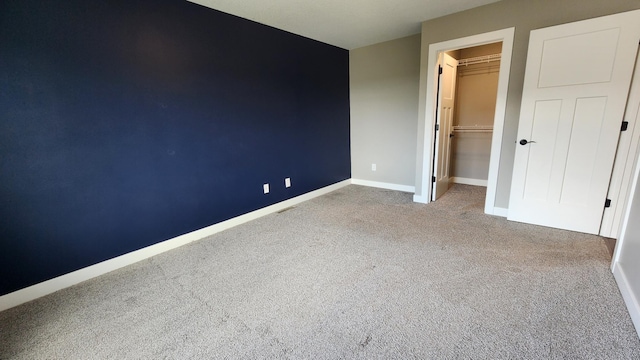 5687 Prosper Ave NW, Rochester, MN 55901 - unfurnished bedroom featuring carpet, a spacious closet, a closet, and baseboards