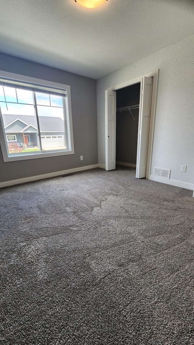 5687 Prosper Ave NW, Rochester, MN 55901 - unfurnished bedroom featuring a closet, carpet, and baseboards