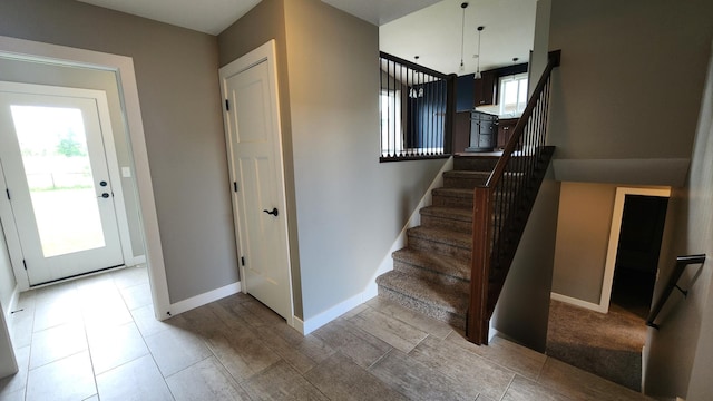 5687 Prosper Ave NW, Rochester, MN 55901 - stairs featuring plenty of natural light and baseboards
