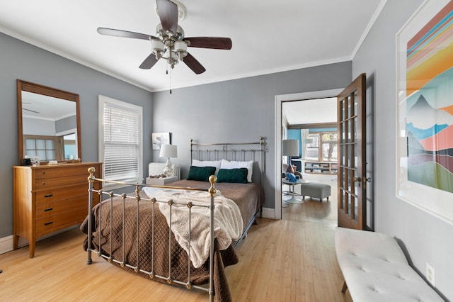 2518 Blaisdell Ave S Unit 1, Minneapolis, MN 55404 - bedroom with multiple windows, wood finished floors, crown molding, a ceiling fan, and baseboards