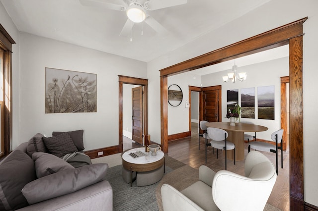 1195 Minnehaha Ave E, Saint Paul, MN 55106 - living area featuring wood finished floors, baseboards, ceiling fan, and a chandelier