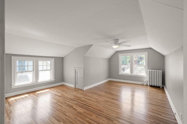 1195 Minnehaha Ave E, Saint Paul, MN 55106 - additional living space featuring radiator, lofted ceiling, wood finished floors, a ceiling fan, and baseboards
