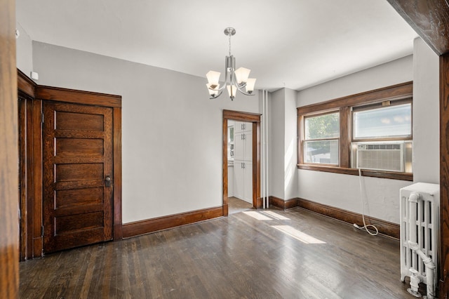 1195 Minnehaha Ave E, Saint Paul, MN 55106 - unfurnished dining area with radiator, a chandelier, wood finished floors, baseboards, and cooling unit