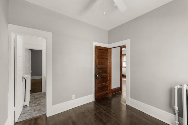 1195 Minnehaha Ave E, Saint Paul, MN 55106 - unfurnished room with radiator, wood finished floors, a ceiling fan, and baseboards