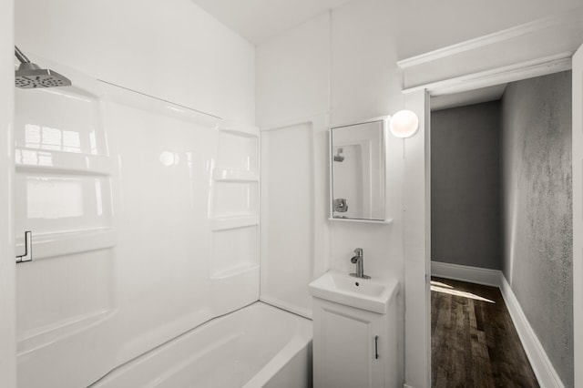 1195 Minnehaha Ave E, Saint Paul, MN 55106 - bathroom with wood finished floors, vanity, tub / shower combination, and baseboards