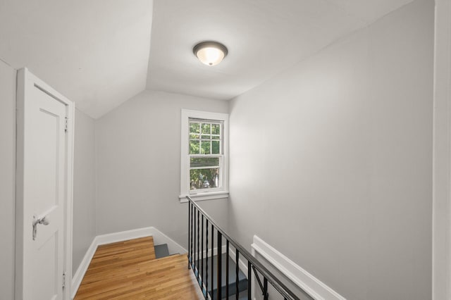 1195 Minnehaha Ave E, Saint Paul, MN 55106 - hallway with an upstairs landing, light wood-style flooring, lofted ceiling, and baseboards