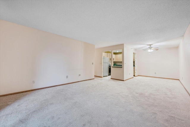 5645 Green Circle Dr Unit 210, Minnetonka, MN 55343 - unfurnished living room featuring a ceiling fan, light carpet, and a textured ceiling